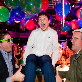 Bar mitzvah boy lifted by guests