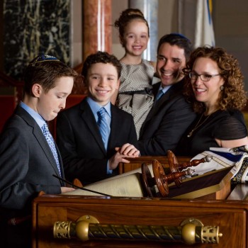 Temple portrait of bar mitzvah boy reading Torah