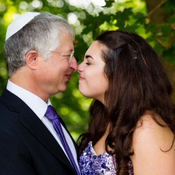 Father and bat mitzvah daughter nose-to-nose
