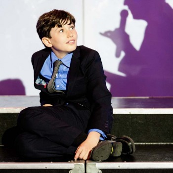Bar mitzvah boy listens to toast from dad