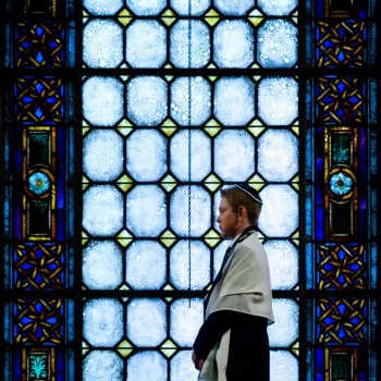 Bar mitzvah boy in front of temple window