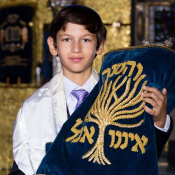 Bar mitzvah boy holding Torah