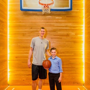 Bar mitzvah boy poses with basketball star