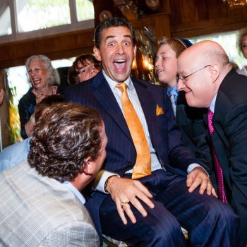 Father lifted up by friends for hora