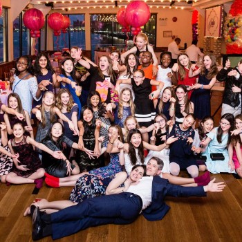 Bat mitzvah party guests gather round
