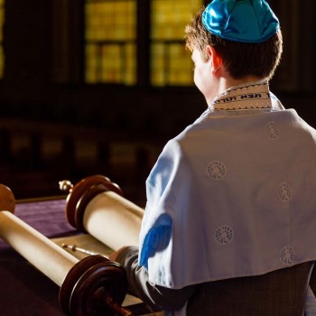 Portrait of boy reading Torah