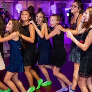 Bat mitvah girl and guests dancing the hora