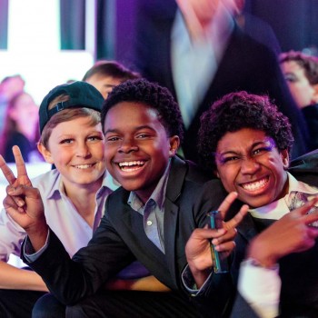 Laughing bar mitzvah guests mug for camera