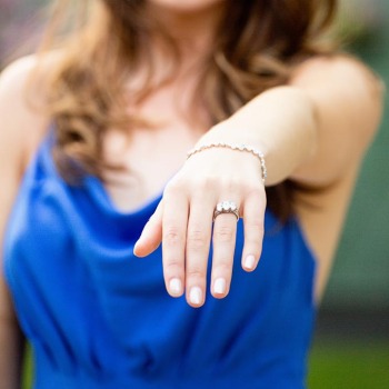 Showing off her engagement ring