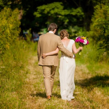 Bride and groom depart ceremony for quiet moment