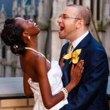 Joyful bride and groom laughing