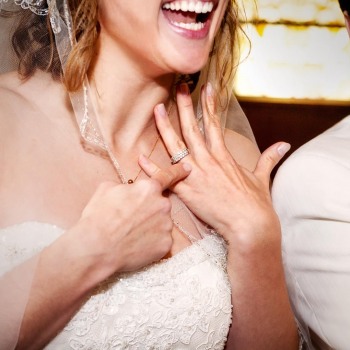 Gleeful bride shows off her wedding ring