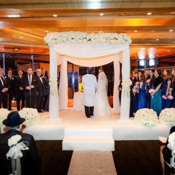 Indoor wedding beneath the chuppah