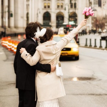 Newlyweds hailing a cab after ceremony