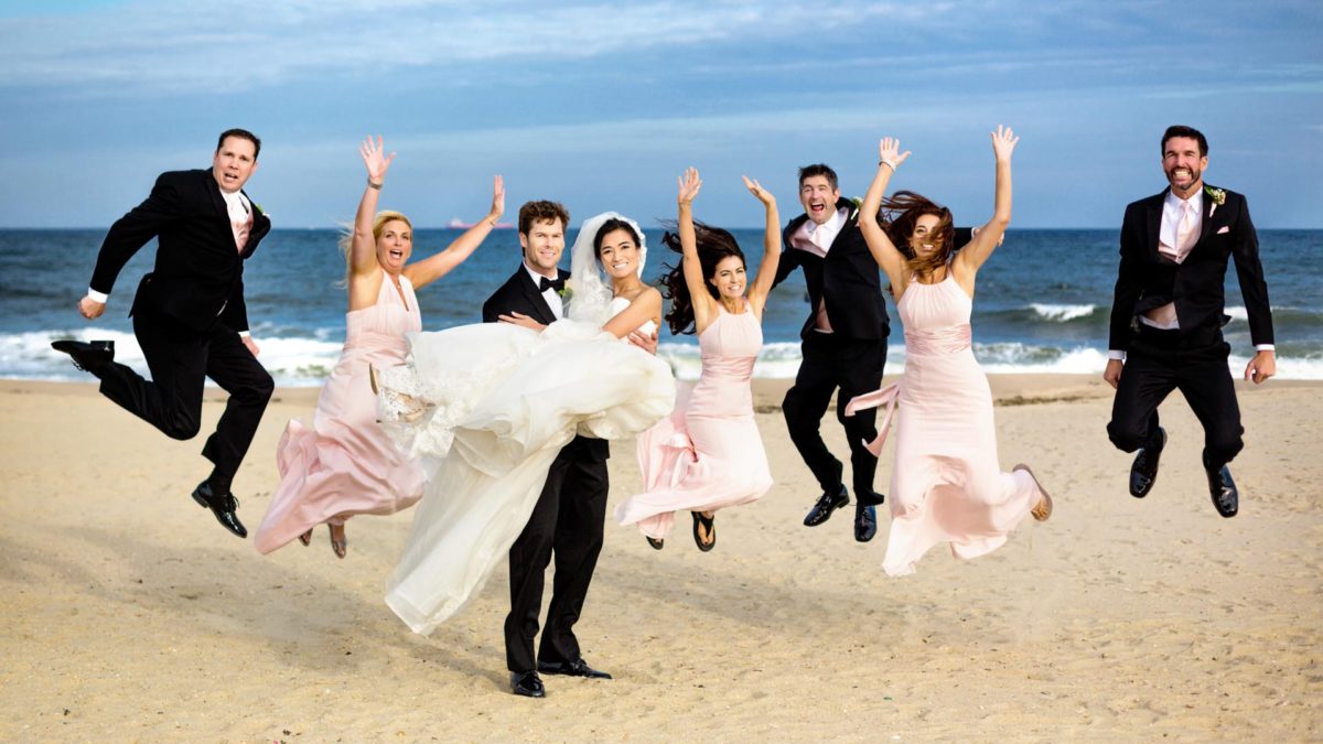 Beach photo of bridal party jumping